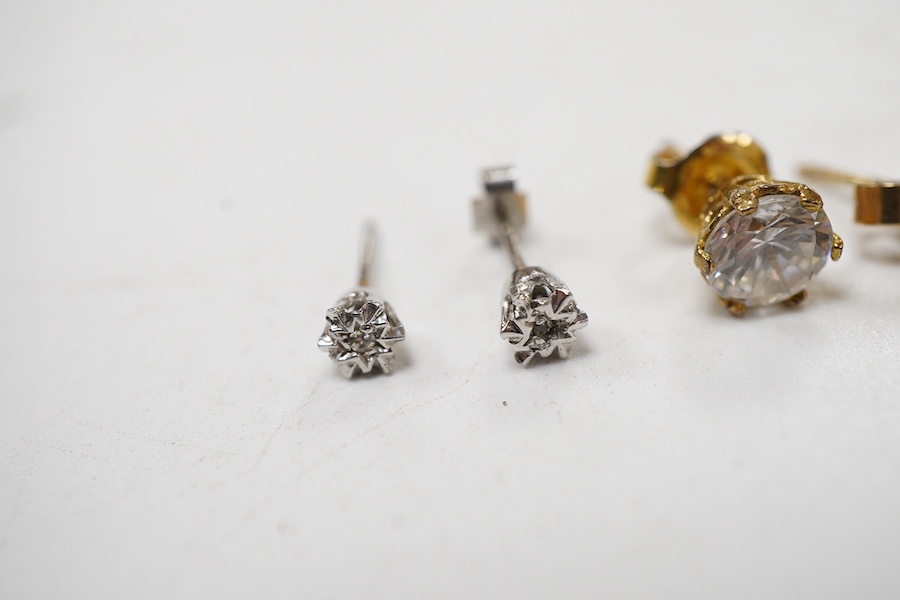 A pair of chequerboard cut peridot set 18ct stud earrings, a pair of amethyst set 9ct stud earrings and three costume pairs of earrings.